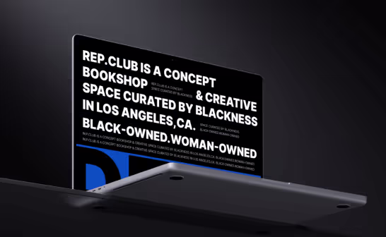 Laptop showing a bookshop website built around bold white type