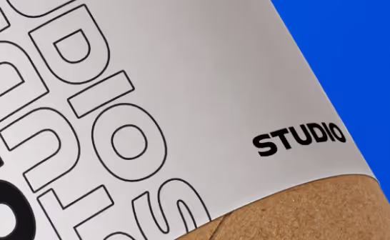 Close-up of the Studio letterhead curling over a blue backdrop