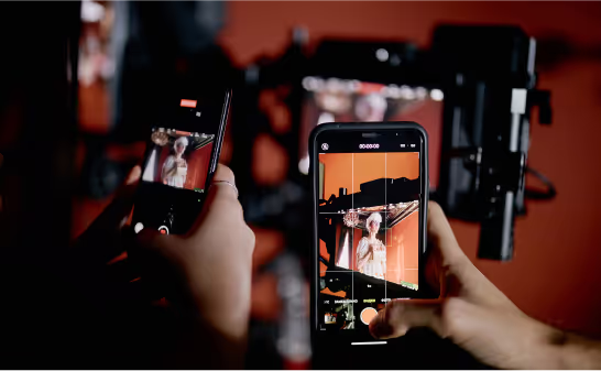 Hands framing a shot on a phone during a photo session